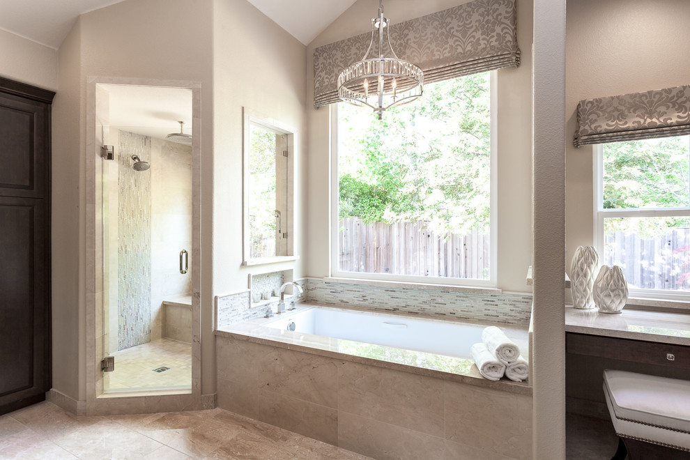 Example of a large transitional master beige tile and stone tile marble floor corner shower design in Sacramento with recessed-panel cabinets, dark wood cabinets, an undermount tub, a one-piece toilet, beige walls, an undermount sink and marble countertops