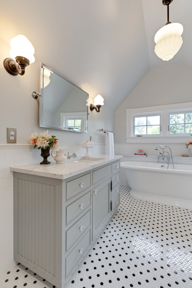 Ornate master white tile and subway tile ceramic tile and multicolored floor freestanding bathtub photo in Portland with gray cabinets, a two-piece toilet, gray walls, an undermount sink, quartz countertops, a hinged shower door and white countertops