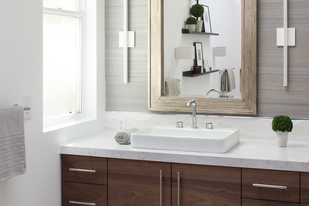 Photo of a large modern ensuite bathroom in Sacramento with flat-panel cabinets, dark wood cabinets, a freestanding bath, a built-in shower, porcelain tiles, white walls, porcelain flooring, a vessel sink, engineered stone worktops, beige tiles and beige floors.