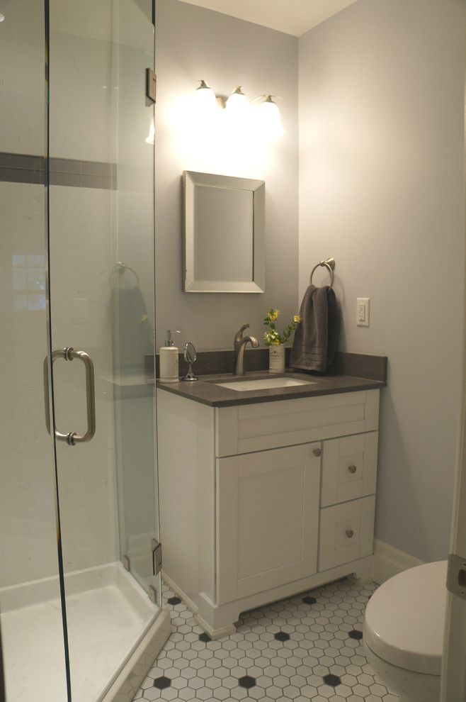Photo of a small traditional shower room bathroom in Toronto with recessed-panel cabinets, white cabinets, a corner shower, a two-piece toilet, white tiles, grey walls, ceramic flooring, a submerged sink and engineered stone worktops.