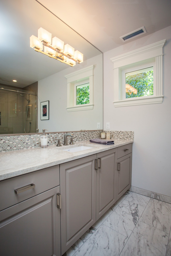 Mid-sized transitional multicolored tile and glass tile marble floor bathroom photo in Portland with raised-panel cabinets, gray cabinets, white walls and quartz countertops