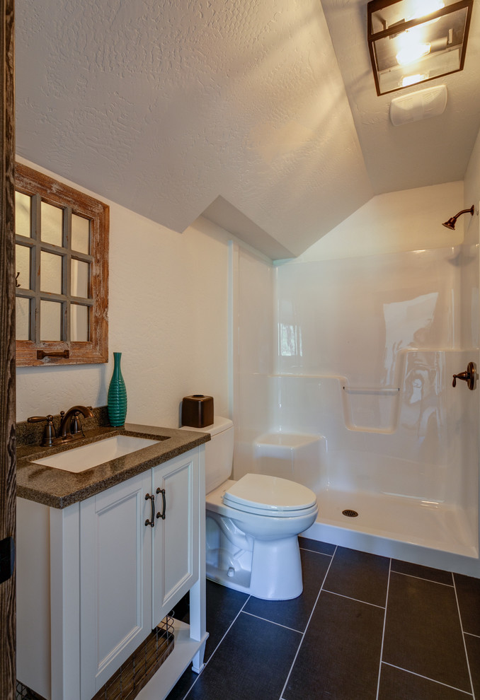 Esempio di una piccola stanza da bagno con doccia rustica con lavabo sottopiano, ante con riquadro incassato, ante bianche, top in granito, WC a due pezzi, pareti bianche e pavimento in gres porcellanato