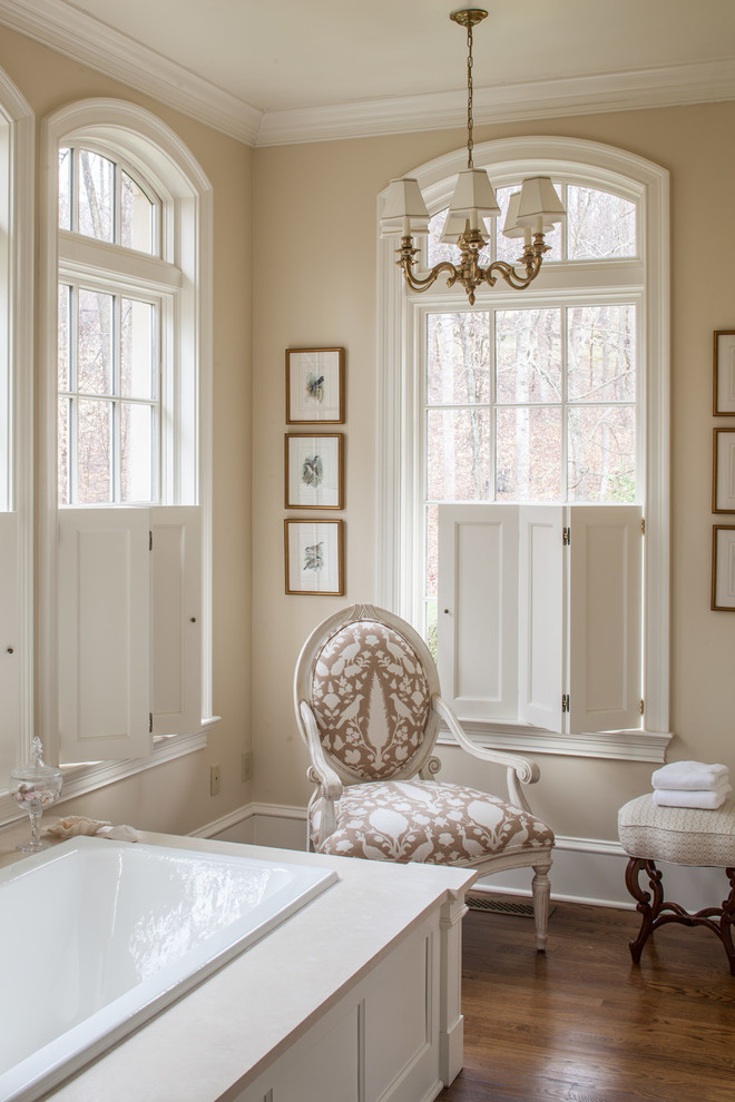 Design ideas for a large traditional ensuite bathroom in DC Metro with beige walls, dark hardwood flooring and a built-in bath.