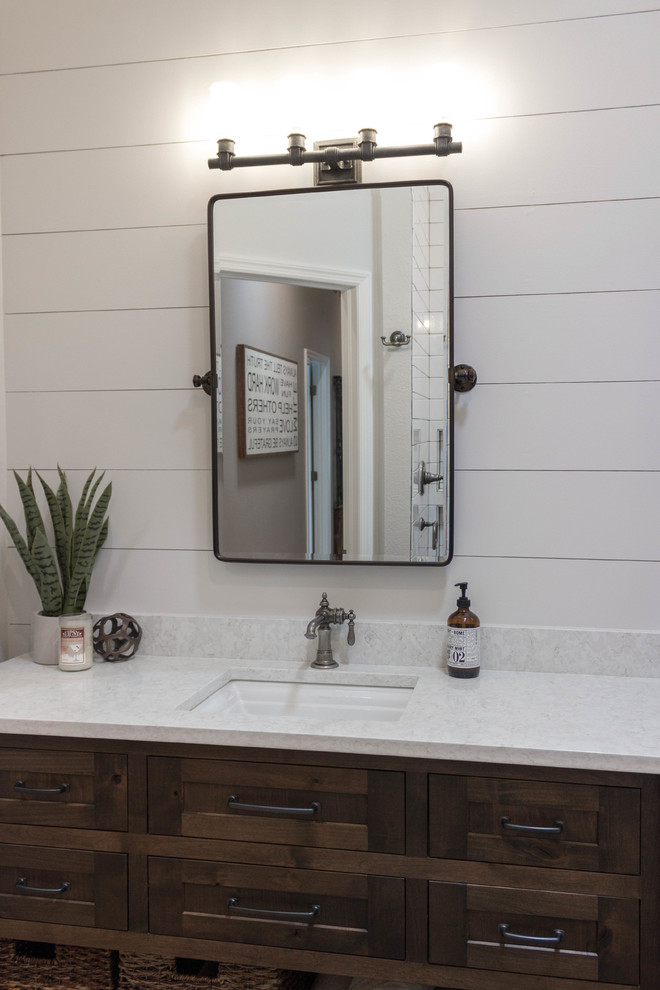 Photo of a rural bathroom in Tampa with freestanding cabinets, medium wood cabinets, white tiles, metro tiles, engineered stone worktops, white worktops and a submerged sink.