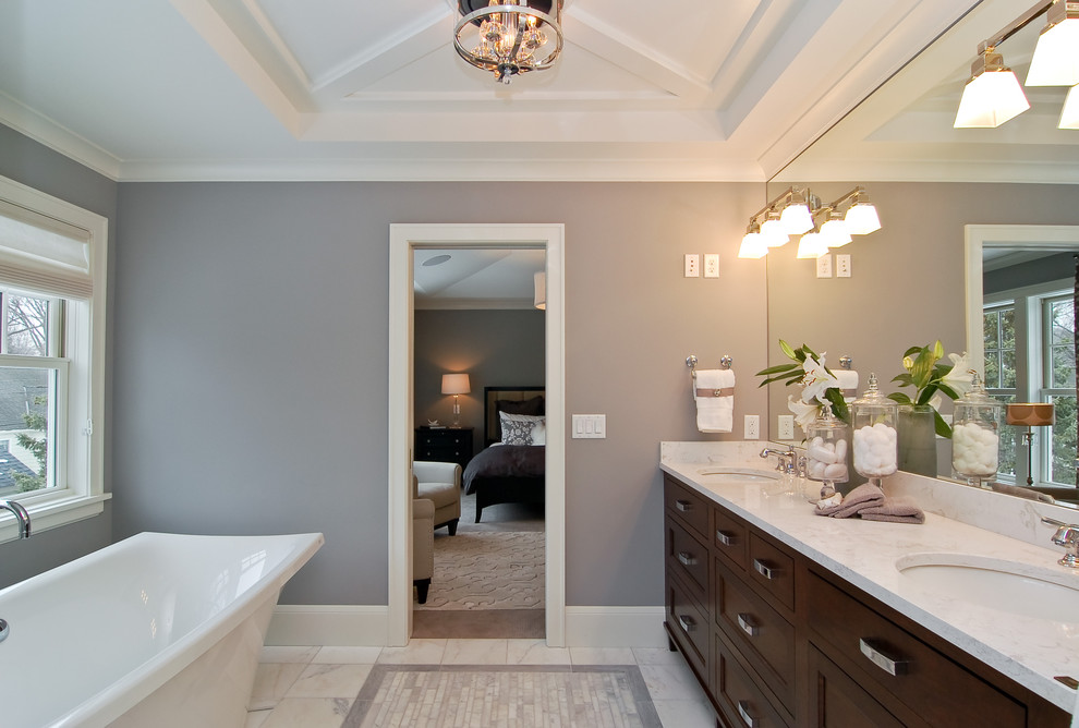 Immagine di una stanza da bagno tradizionale con vasca freestanding e top in marmo