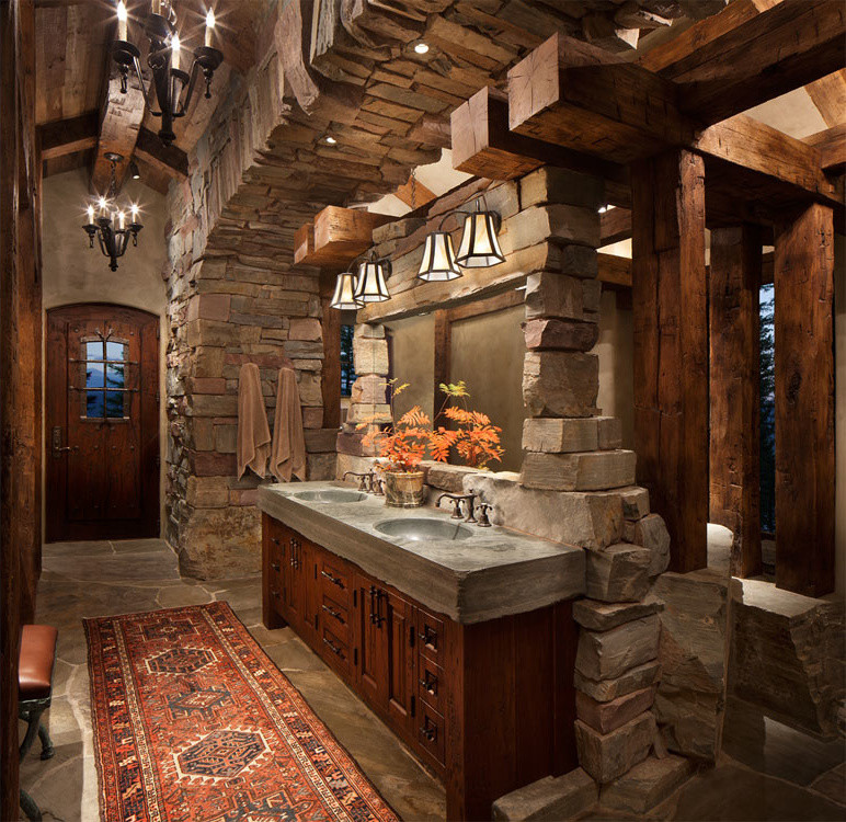 Large mountain style master stone tile slate floor bathroom photo in Other with raised-panel cabinets, dark wood cabinets, brown walls, an integrated sink and solid surface countertops