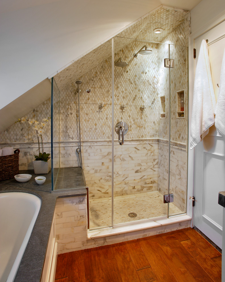Inspiration for a medium sized traditional ensuite bathroom in New York with shaker cabinets, white cabinets, a submerged bath, an alcove shower, a wall mounted toilet, white tiles, metro tiles, beige walls, medium hardwood flooring, a vessel sink, soapstone worktops, brown floors and a hinged door.