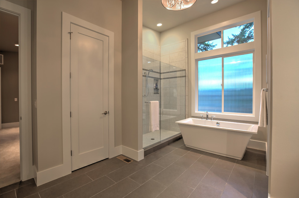 Стильный дизайн: большая главная ванная комната в современном стиле с отдельно стоящей ванной, душем в нише, серой плиткой и серыми стенами - последний тренд