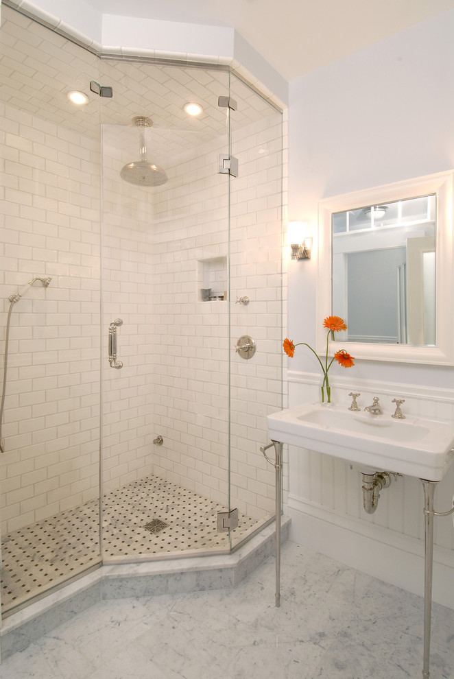Elegant subway tile marble floor corner shower photo in Boston with a console sink
