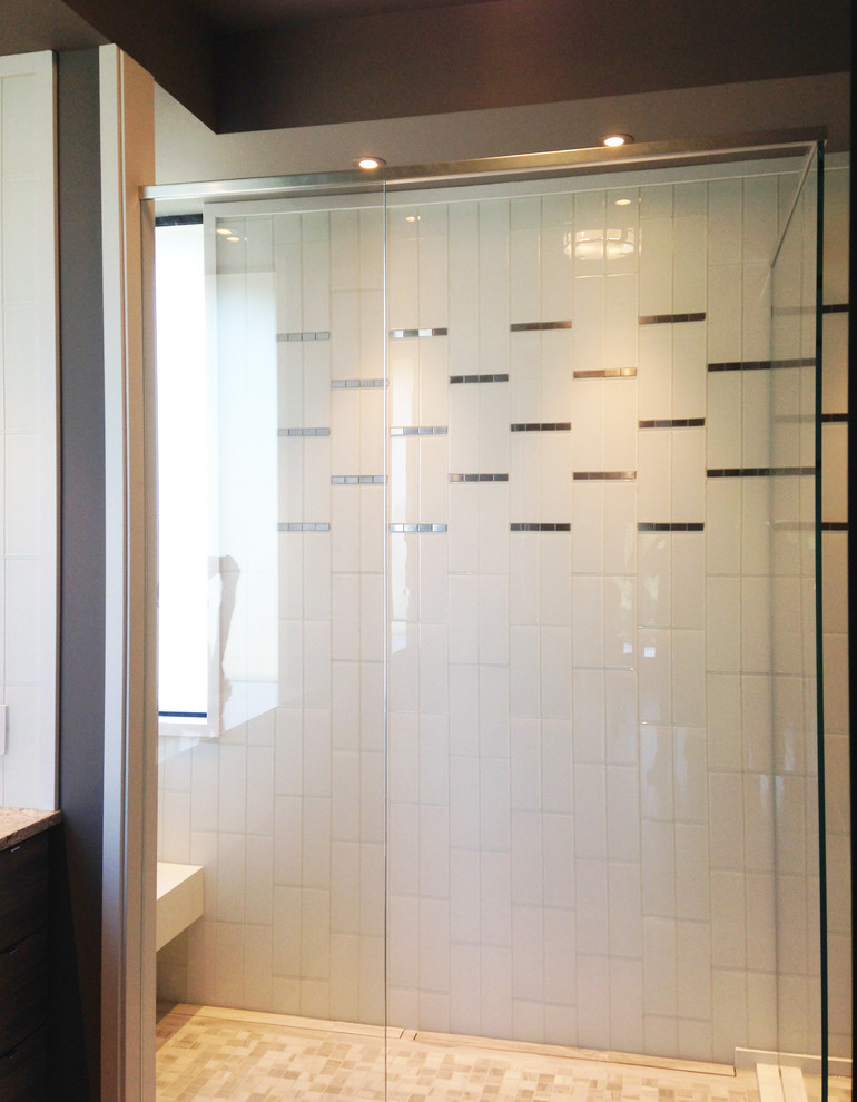 Photo of a medium sized contemporary shower room bathroom in Denver with white tiles, grey walls, a submerged sink, engineered stone worktops, flat-panel cabinets, grey cabinets, a built-in shower, a one-piece toilet, glass tiles and ceramic flooring.