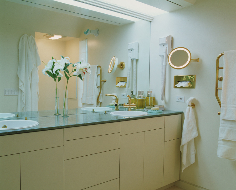Diseño de cuarto de baño actual con lavabo encastrado, armarios con paneles lisos y puertas de armario beige