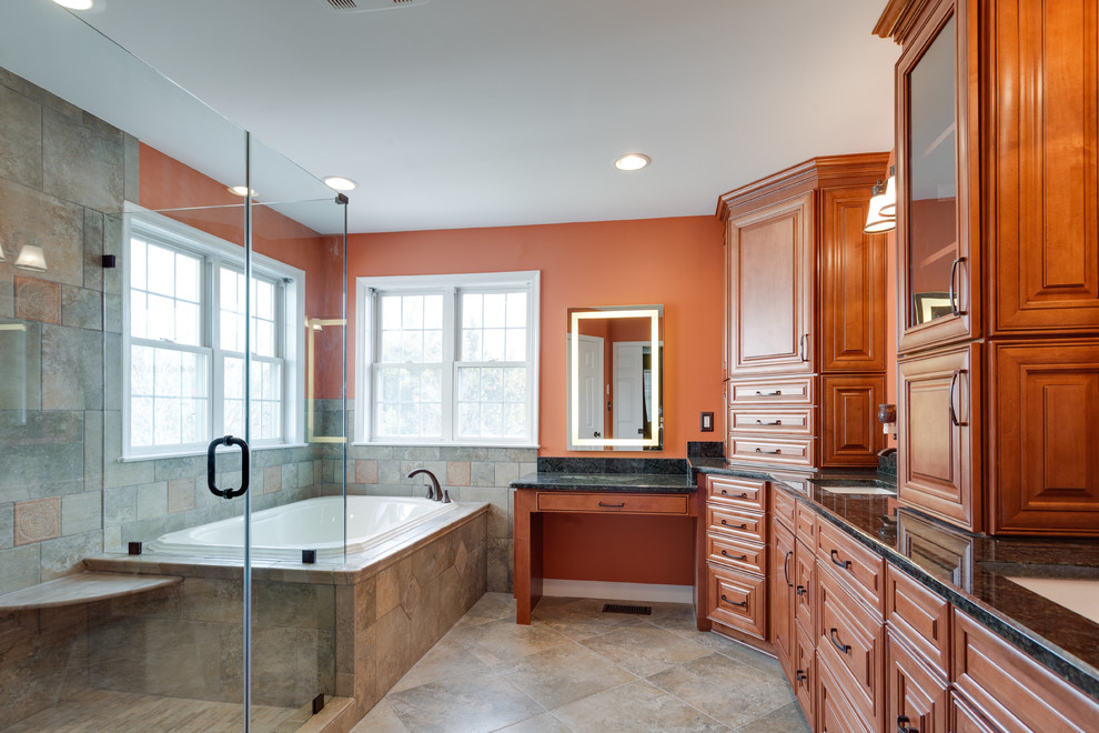 Inspiration for a large classic ensuite bathroom in DC Metro with raised-panel cabinets, medium wood cabinets, a built-in bath, a corner shower, ceramic flooring, a submerged sink, granite worktops and a hinged door.