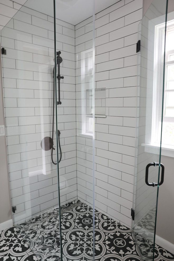 Design ideas for a medium sized country shower room bathroom in New York with dark wood cabinets, black and white tiles, grey walls, cement flooring, white worktops, freestanding cabinets, a walk-in shower, a two-piece toilet, an integrated sink, multi-coloured floors and a hinged door.