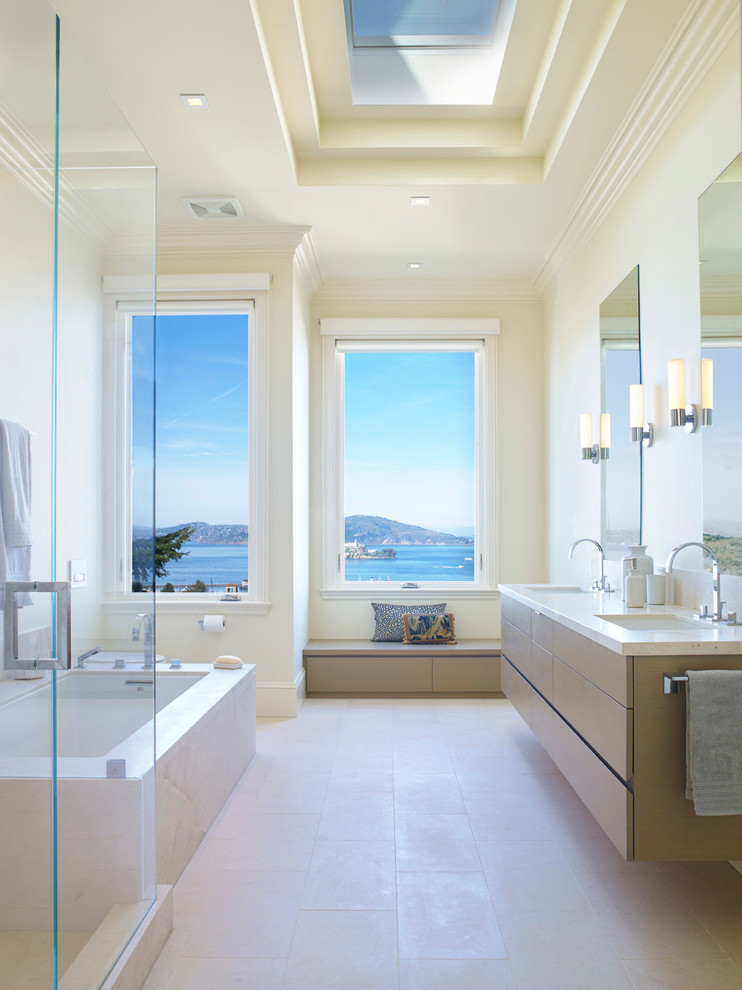 Inspiration for a contemporary master bathroom remodel in San Francisco with flat-panel cabinets, light wood cabinets, an undermount tub and beige walls