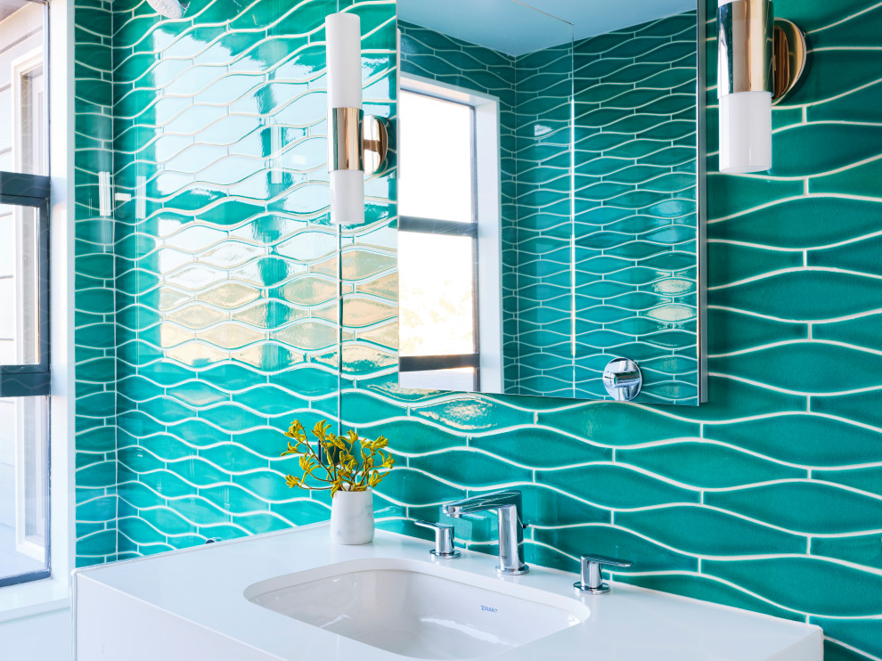 This is an example of a medium sized beach style family bathroom in San Francisco with white cabinets, an alcove bath, a shower/bath combination, green tiles, ceramic tiles, green walls, an open shower, white worktops and a single sink.