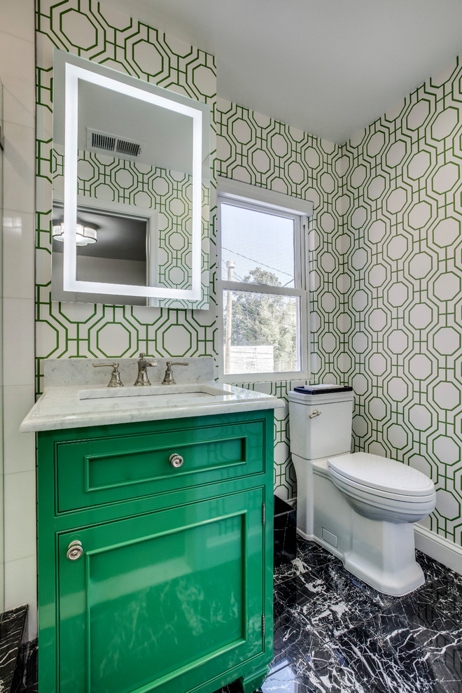 Klassisk inredning av ett litet vit vitt badrum med dusch, med luckor med profilerade fronter, gröna skåp, en hörndusch, en toalettstol med hel cisternkåpa, vit kakel, marmorkakel, marmorgolv, ett undermonterad handfat, marmorbänkskiva, svart golv och dusch med gångjärnsdörr