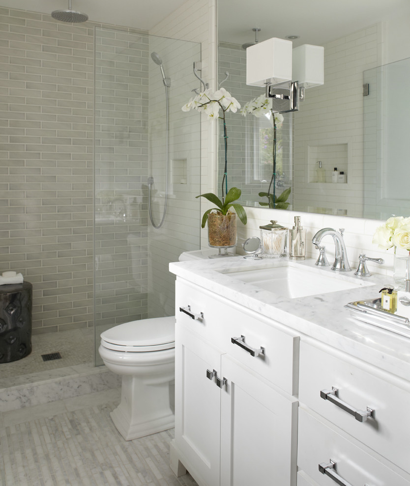Example of a transitional subway tile bathroom design in San Francisco with marble countertops and white countertops
