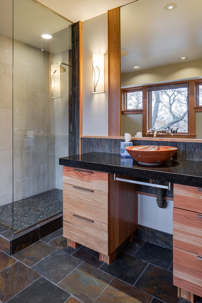 Design ideas for a large modern ensuite bathroom in Minneapolis with a vessel sink, flat-panel cabinets, medium wood cabinets, a corner shower and beige walls.
