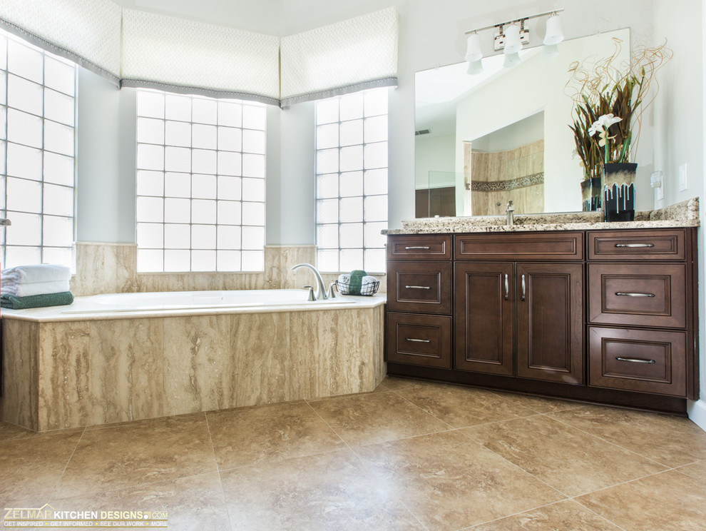 Inspiration for a mid-sized timeless master beige tile and stone tile porcelain tile doorless shower remodel in Orlando with an undermount sink, recessed-panel cabinets, brown cabinets and granite countertops