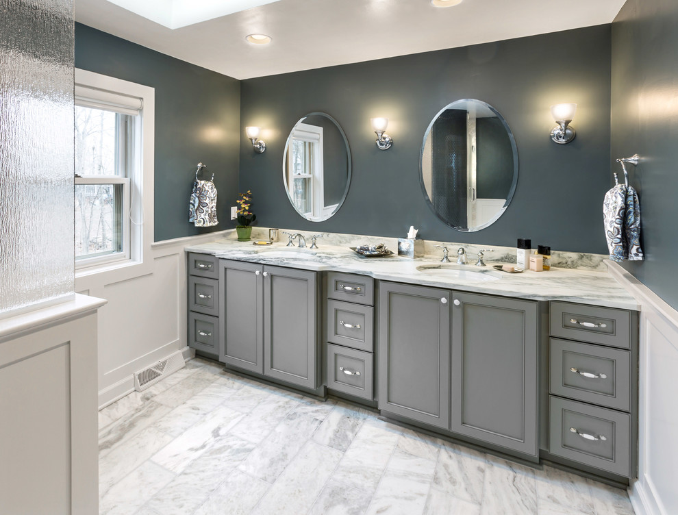 Large classic ensuite bathroom in Milwaukee with a submerged sink, recessed-panel cabinets, grey cabinets, marble worktops, an alcove shower, a two-piece toilet, white tiles, stone tiles, grey walls and marble flooring.
