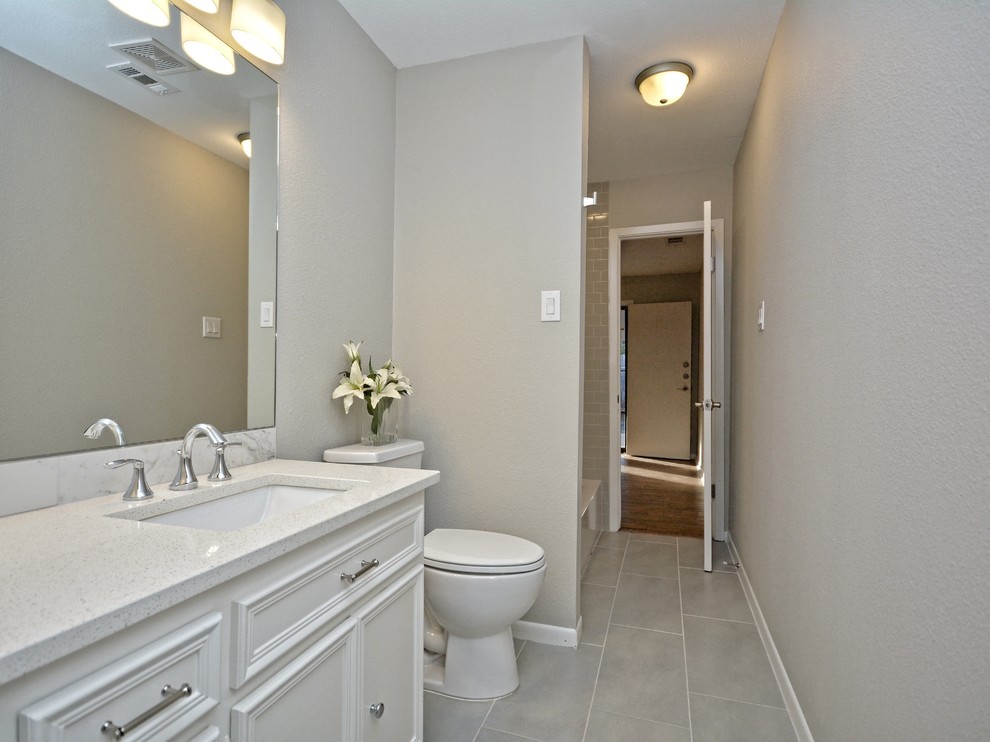 Mid-sized elegant master gray tile and porcelain tile medium tone wood floor bathroom photo in Austin with shaker cabinets, white cabinets, gray walls, an undermount sink and quartzite countertops