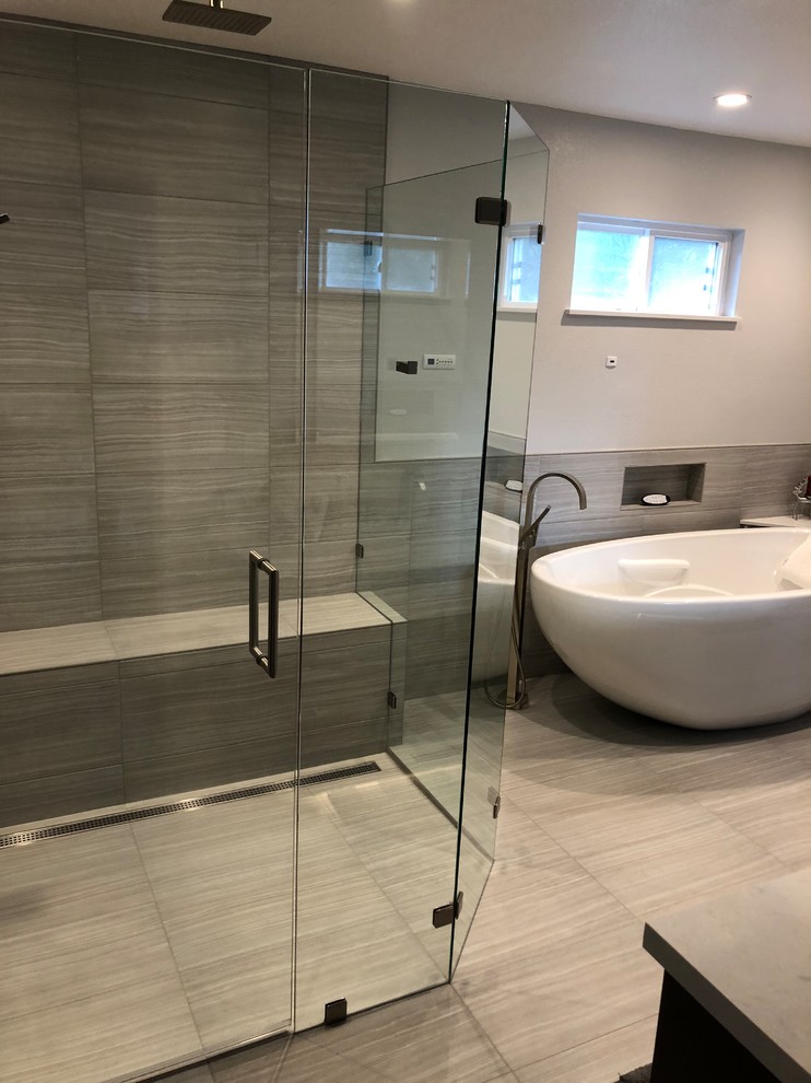 Mid-sized trendy master beige tile and porcelain tile porcelain tile and beige floor bathroom photo in Sacramento with recessed-panel cabinets, dark wood cabinets, a two-piece toilet, gray walls, an undermount sink, quartzite countertops, a hinged shower door and white countertops