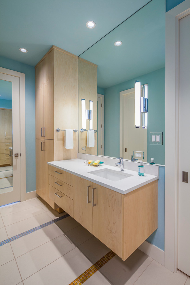 Inspiration for a contemporary kids' white tile and porcelain tile porcelain tile bathroom remodel in Austin with an undermount sink, light wood cabinets, quartz countertops and blue walls