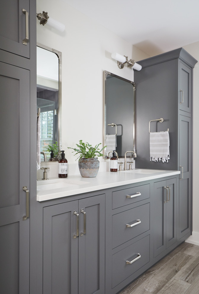 Large farmhouse kids' porcelain tile medium tone wood floor, gray floor, double-sink and vaulted ceiling bathroom photo in Grand Rapids with recessed-panel cabinets, gray cabinets, a two-piece toilet, white walls, an undermount sink, quartz countertops, white countertops and a built-in vanity