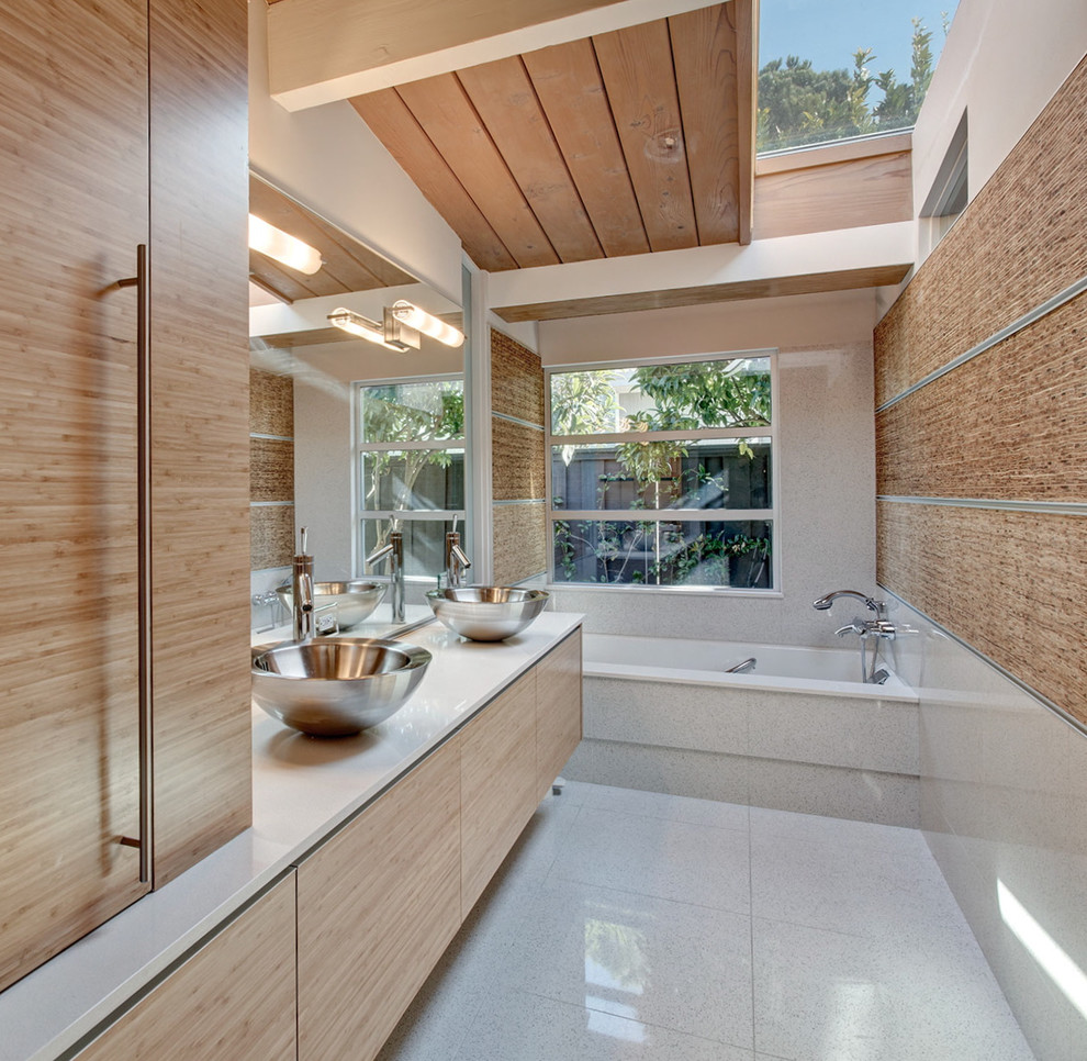 Design ideas for a contemporary bathroom in San Francisco with flat-panel cabinets, light wood cabinets, a built-in bath, a shower/bath combination, grey tiles, white walls, a vessel sink, grey floors, an open shower and white worktops.