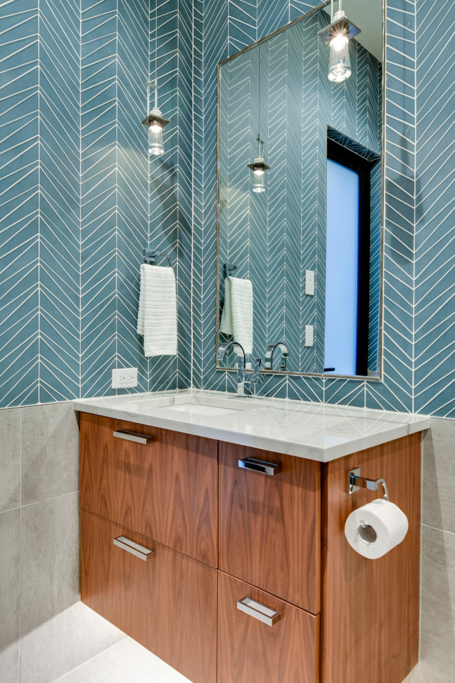 Contemporary bathroom in Austin with flat-panel cabinets, medium wood cabinets, blue tiles, glass tiles, a submerged sink, grey floors and white worktops.