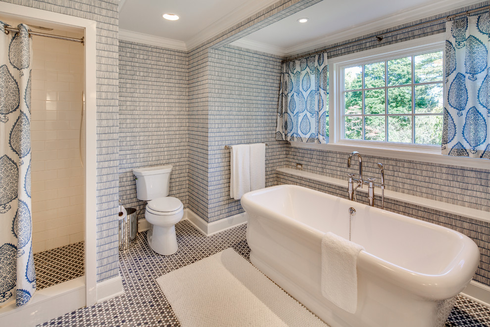 Traditional ensuite bathroom in New York with a freestanding bath, a corner shower, a two-piece toilet, blue walls, mosaic tile flooring and a shower curtain.