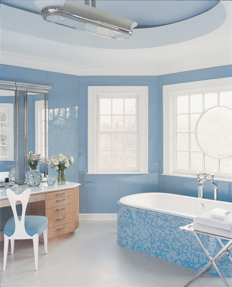 Transitional master multicolored tile and mosaic tile drop-in bathtub photo in New York with blue walls, light wood cabinets and flat-panel cabinets