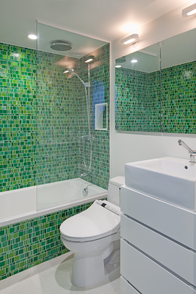 This is an example of an eclectic bathroom in New York with mosaic tiles, a vessel sink and green tiles.