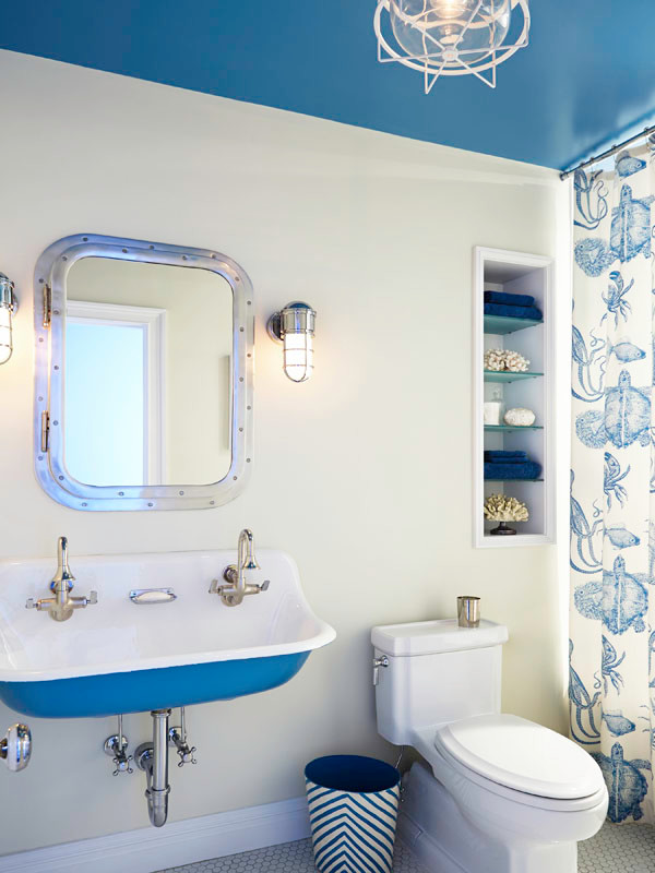 Medium sized beach style family bathroom in New York with recessed-panel cabinets, white cabinets, an alcove shower, a two-piece toilet, yellow walls, medium hardwood flooring, a wall-mounted sink, white floors and a shower curtain.