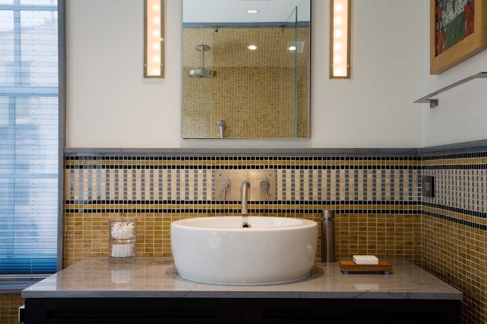 This is an example of a contemporary bathroom in New York with a vessel sink, mosaic tiles and feature lighting.