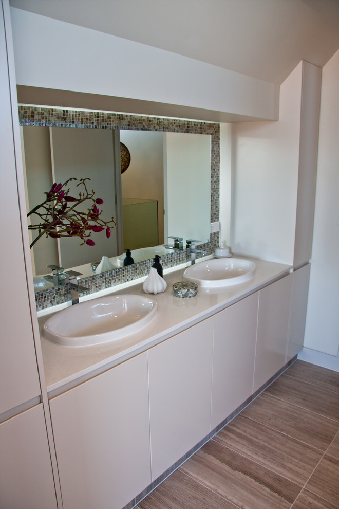 This is an example of a medium sized contemporary bathroom in Sydney with mosaic tiles, white walls, ceramic flooring and white tiles.