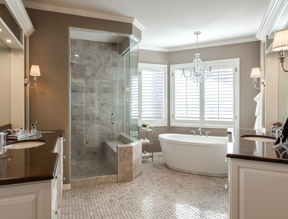 Design ideas for a large traditional ensuite bathroom in Denver with a submerged sink, raised-panel cabinets, white cabinets, marble worktops, a freestanding bath, a built-in shower, beige tiles, mosaic tiles, brown walls and mosaic tile flooring.