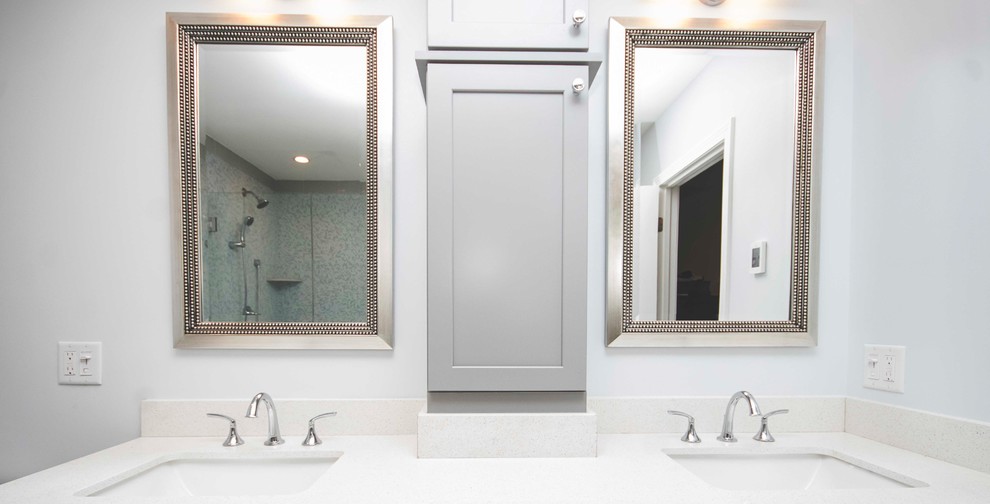 Large modern ensuite bathroom in Providence with recessed-panel cabinets, grey cabinets, a built-in bath, a corner shower, a two-piece toilet, grey tiles, ceramic tiles, grey walls, ceramic flooring, a submerged sink, quartz worktops, beige floors and a hinged door.