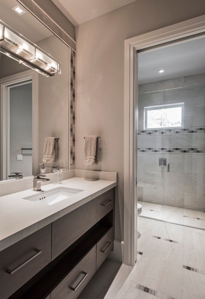 Inspiration for a medium sized traditional family bathroom in Miami with flat-panel cabinets, dark wood cabinets, an alcove shower, beige tiles, porcelain tiles, beige walls, porcelain flooring, a submerged sink and solid surface worktops.