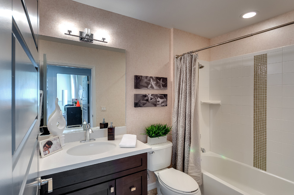 Small trendy 3/4 bathroom photo in Tampa with an undermount sink, shaker cabinets, dark wood cabinets, laminate countertops and a one-piece toilet