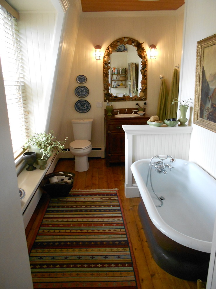 Inspiration for a mid-sized eclectic master white tile and subway tile medium tone wood floor bathroom remodel in Other with raised-panel cabinets, dark wood cabinets, a one-piece toilet, white walls, a drop-in sink and wood countertops