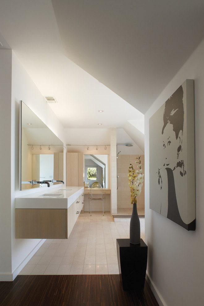 Inspiration for a small modern master beige tile and stone tile limestone floor bathroom remodel in Los Angeles with an undermount sink, flat-panel cabinets, light wood cabinets, solid surface countertops and white walls