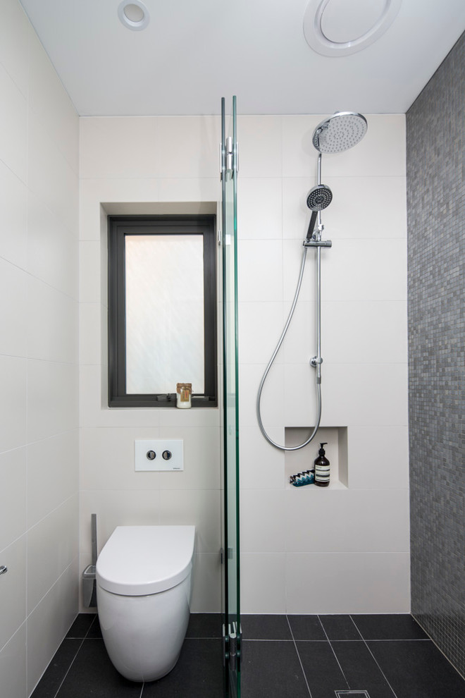 Idéer för små skandinaviska badrum, med bänkskiva i akrylsten, en öppen dusch, en toalettstol med hel cisternkåpa, grå kakel, mosaik, vita väggar, klinkergolv i porslin, ett väggmonterat handfat, svart golv och med dusch som är öppen