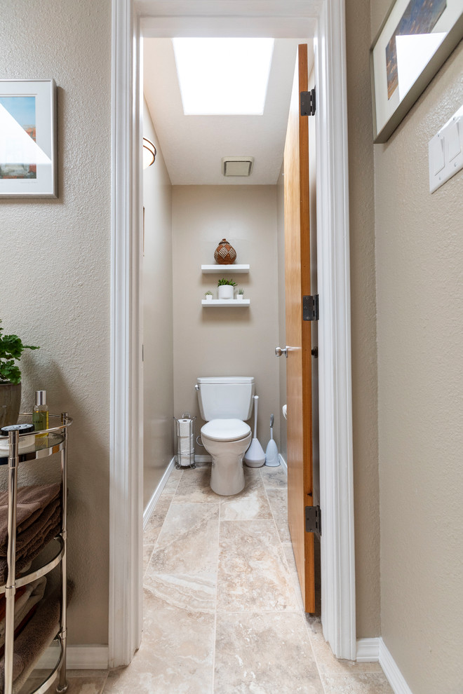 Inspiration for a large modern ensuite bathroom in Albuquerque with flat-panel cabinets, white cabinets, a corner bath, a corner shower, a one-piece toilet, beige tiles, ceramic tiles, beige walls, ceramic flooring, a vessel sink, engineered stone worktops, beige floors, a hinged door and beige worktops.