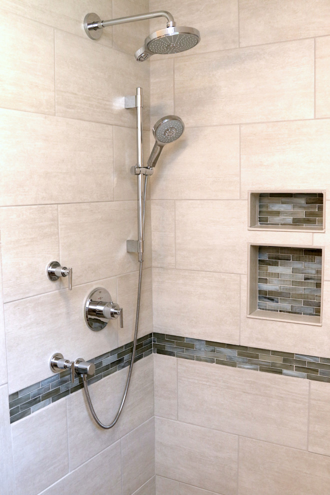 Mid-sized trendy master porcelain tile pebble tile floor alcove shower photo in Other with an undermount sink, raised-panel cabinets, white cabinets, quartz countertops and a two-piece toilet
