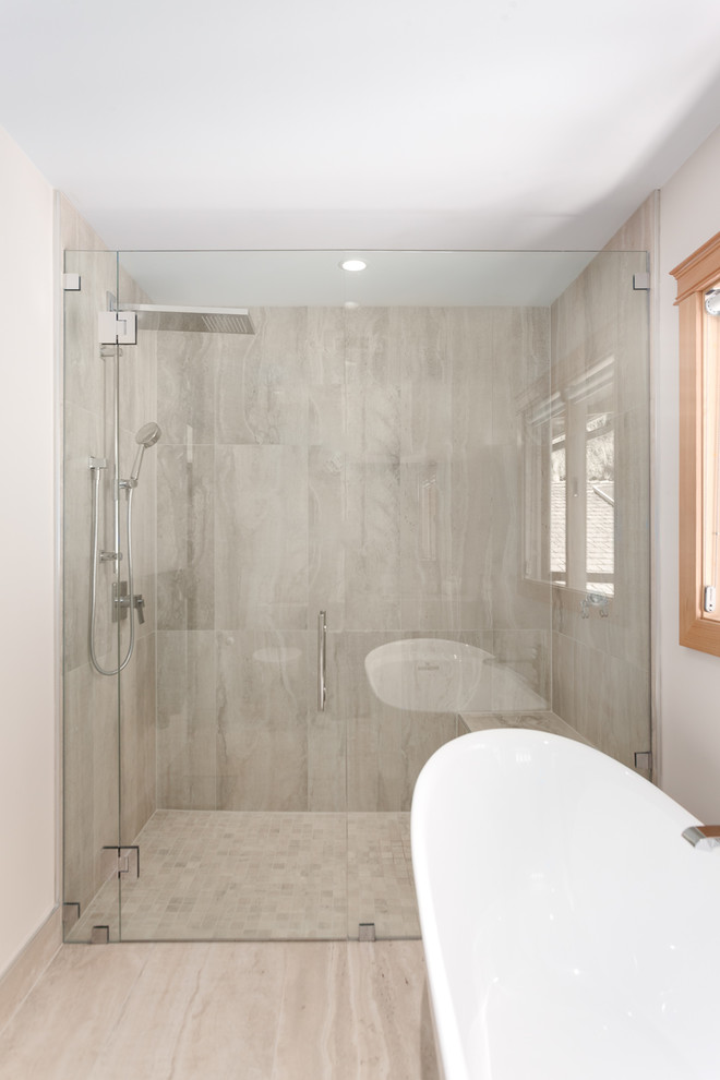 This is an example of a medium sized classic ensuite bathroom in Vancouver with shaker cabinets, dark wood cabinets, a freestanding bath, a built-in shower, a one-piece toilet, white walls, porcelain flooring, a submerged sink, quartz worktops, beige floors, a hinged door, white tiles and limestone tiles.