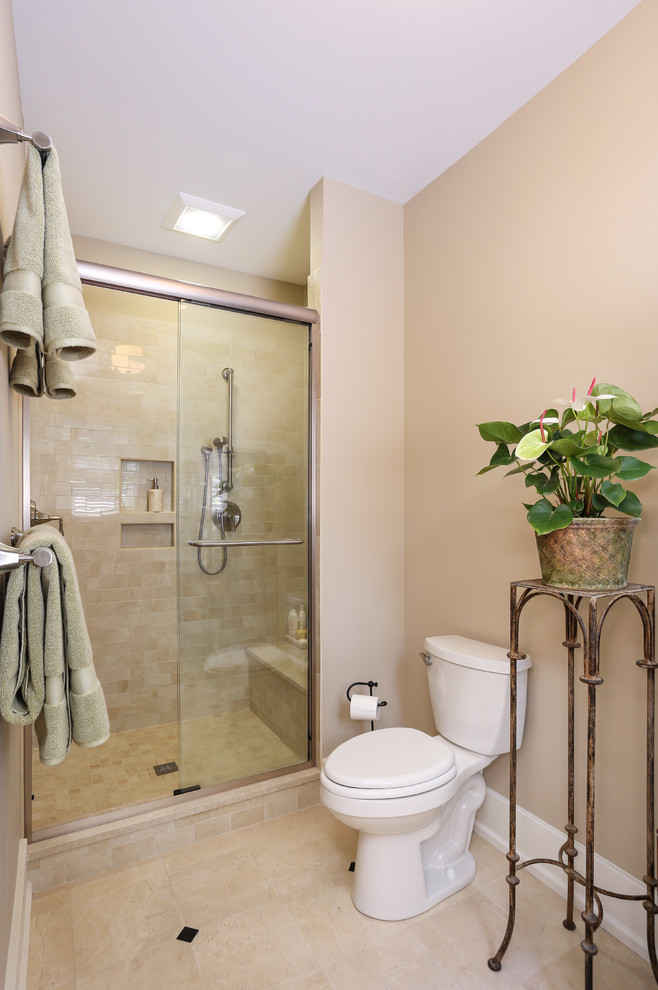 Small traditional ensuite bathroom in Charleston with an alcove shower, a two-piece toilet, beige tiles, porcelain tiles, beige walls and porcelain flooring.