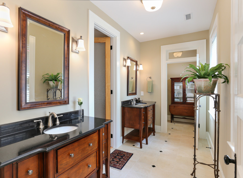 Mid-sized elegant master beige tile and porcelain tile porcelain tile bathroom photo in Charleston with an undermount sink, dark wood cabinets, beige walls and recessed-panel cabinets