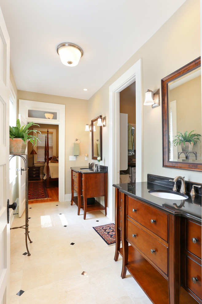 Design ideas for a medium sized traditional ensuite bathroom in Charleston with a submerged sink, brown cabinets, beige tiles, freestanding cabinets, granite worktops, porcelain tiles, beige walls and porcelain flooring.