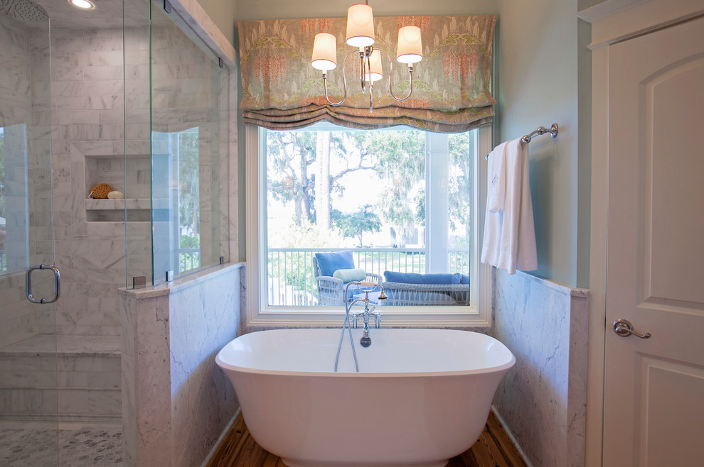 Inspiration for a large traditional ensuite bathroom in Atlanta with recessed-panel cabinets, grey cabinets, a freestanding bath, a corner shower, a two-piece toilet, white tiles, marble tiles, blue walls, medium hardwood flooring, a submerged sink and marble worktops.